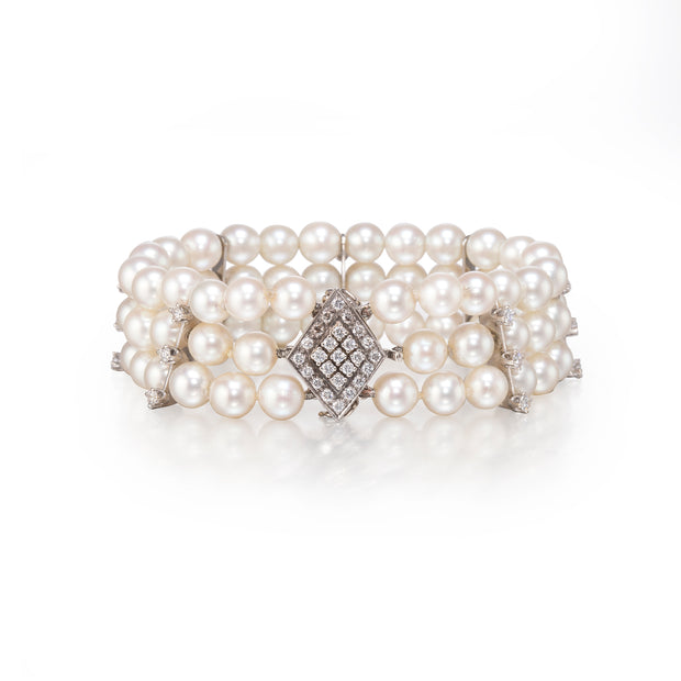 Pearl bracelet with diamond clasp on a white background